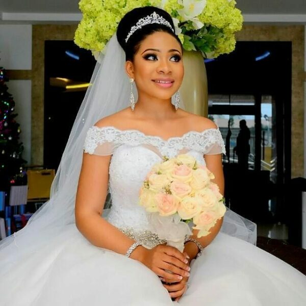 Beautiful bride holding a bridal bouquet of flowers roses