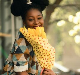 black girl holding flowers and smiling