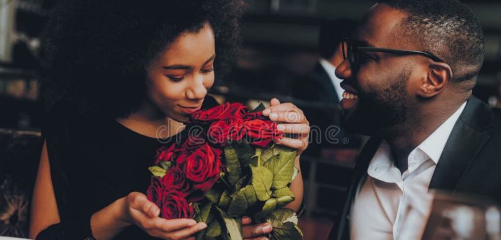 black couple dining with flowers