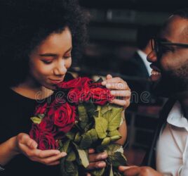 black couple dining with flowers