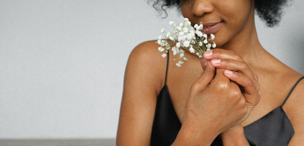 Lady in Lagos Nigeria smelling flowers