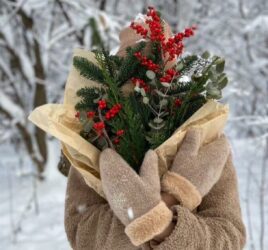 A LADY STANDING IN THE SNOW ON CHRISTMAS