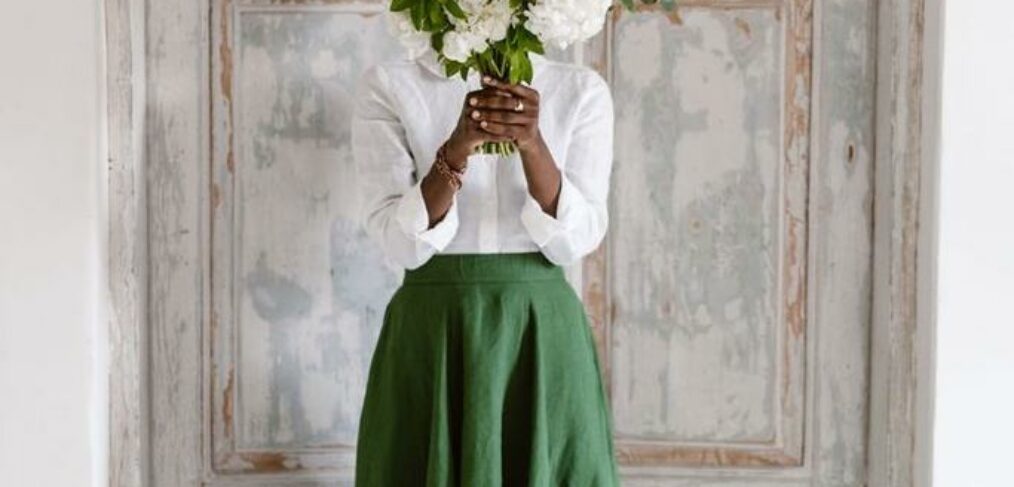 Black woman covering her face with fresh flowers