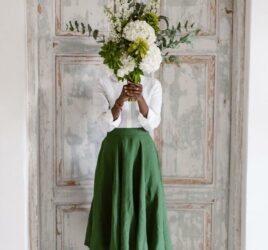 Black woman covering her face with fresh flowers