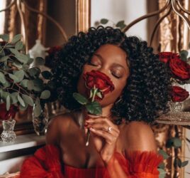 LADY-WEARING-RED-DRESS-SMELLING-RED-ROSES-.jpeg