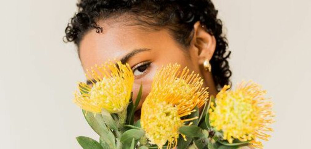 LADY HOLDING YELLOW FLOWERS