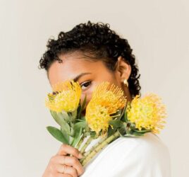 LADY HOLDING YELLOW FLOWERS